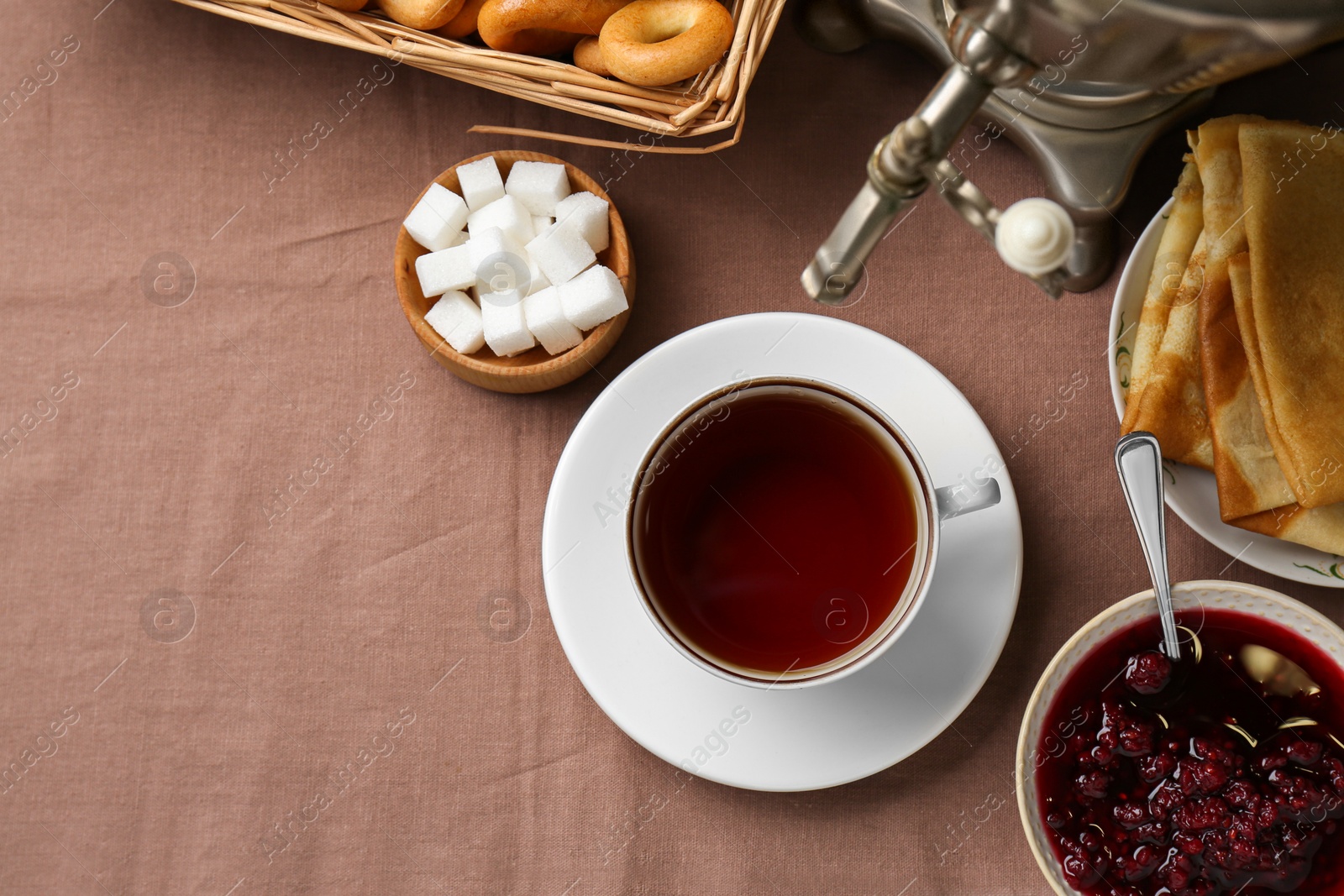 Photo of Flat lay composition with aromatic tea and treats on table. Space for text