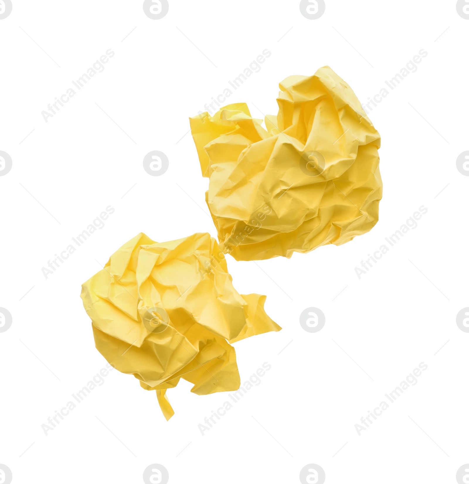 Photo of Crumpled sheets of yellow paper on white background, top view