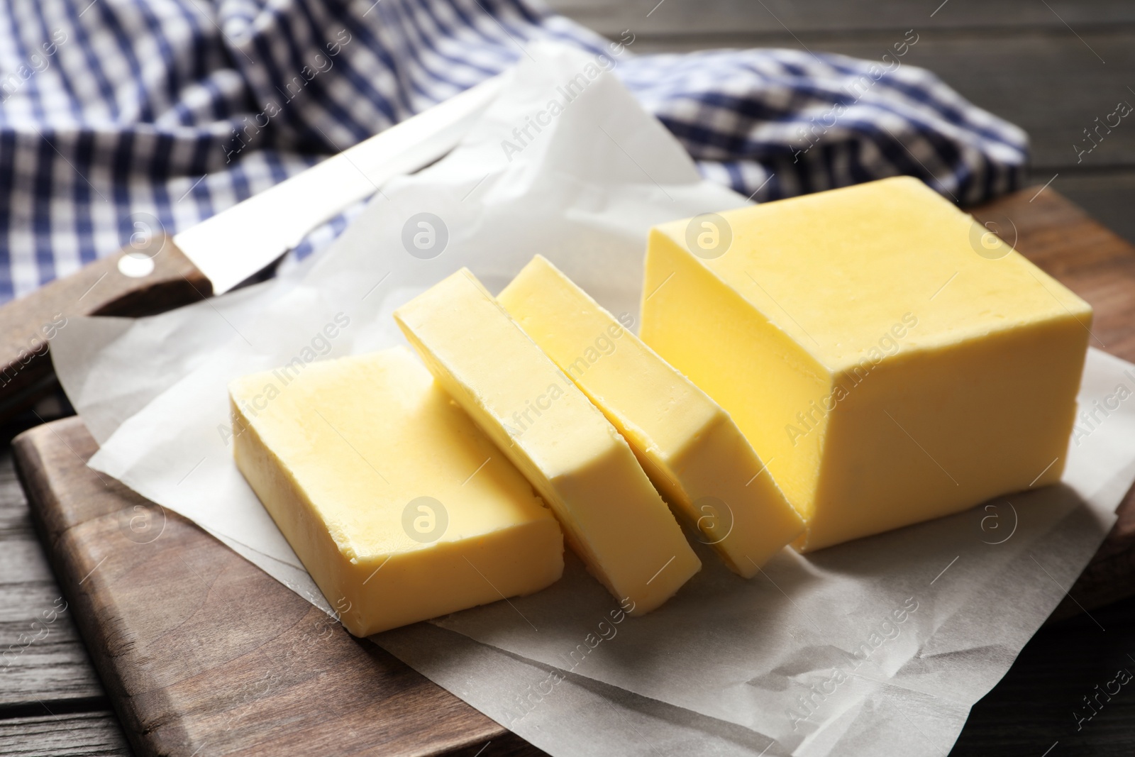 Photo of Wooden board with fresh butter on table, closeup