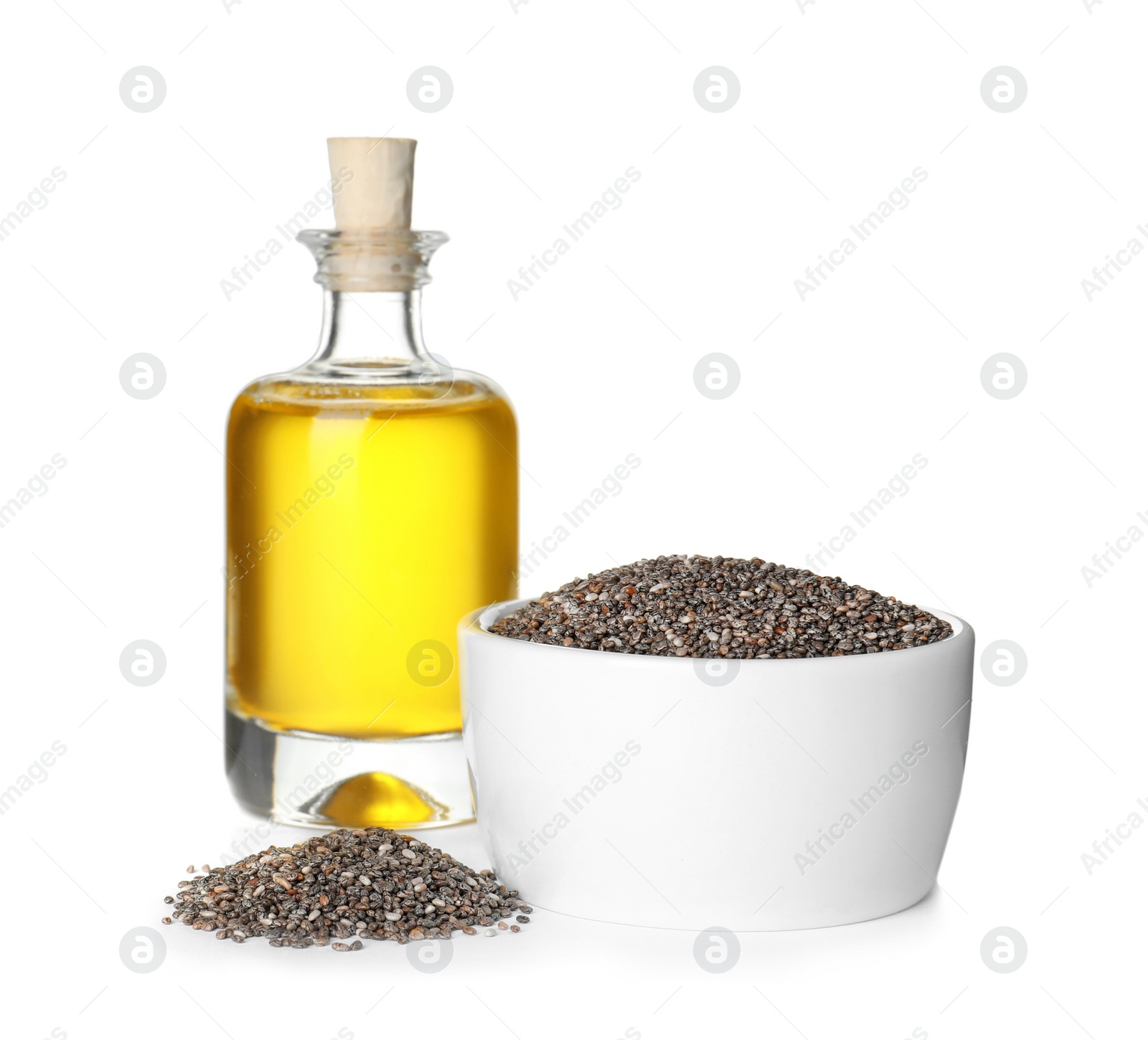 Photo of Bottle of chia oil, bowl and seeds on white background