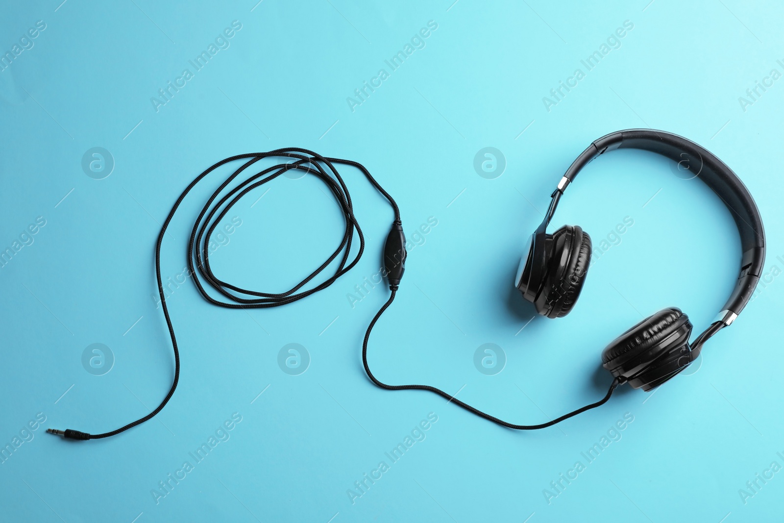 Photo of Stylish headphones on color background, top view