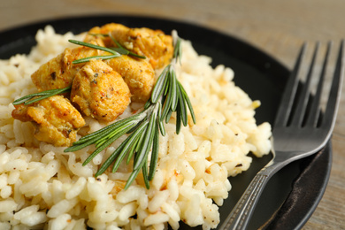 Delicious risotto with chicken on plate, closeup