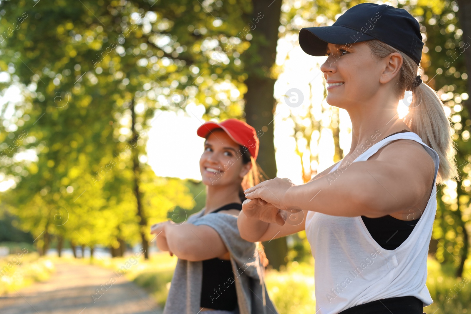 Photo of Women doing morning exercise in park, space for text