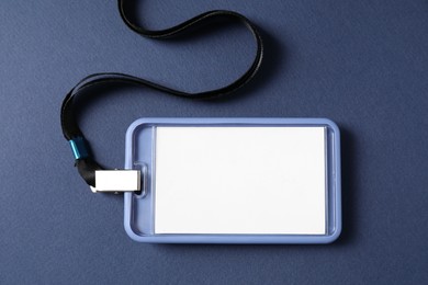 Photo of Blank badge with string on blue background, top view