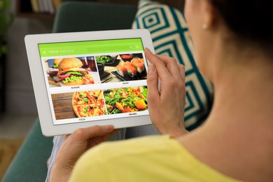 Photo of Woman using tablet for ordering food online at home, closeup. Concept of delivery service