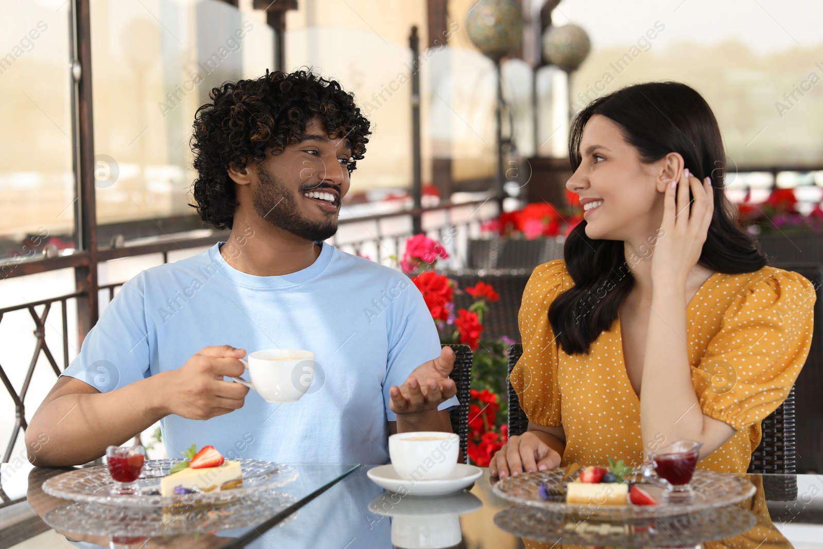 Photo of International dating. Happy couple spending time together in restaurant