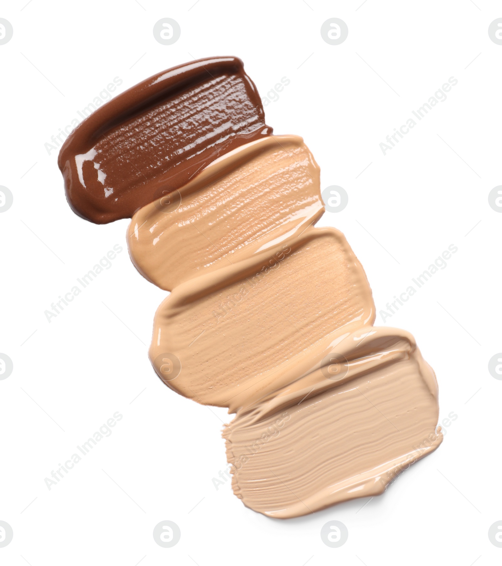 Photo of Samples of skin foundation on white background, top view