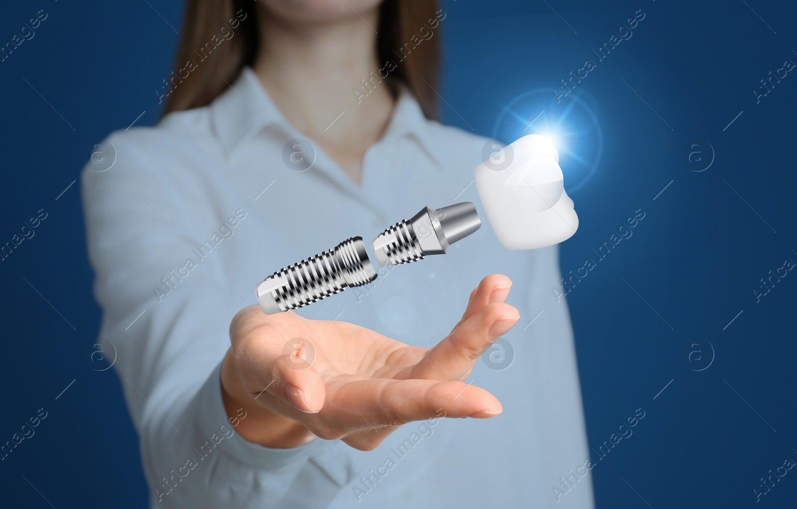 Image of Woman demonstrating dental implant on blue background, closeup