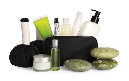 Compact toiletry bag, spa stones and different cosmetic products isolated on white