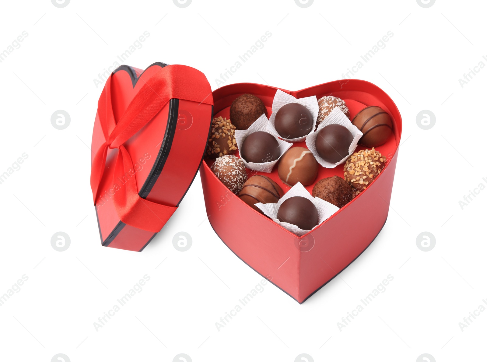 Photo of Heart shaped box with delicious chocolate candies isolated on white