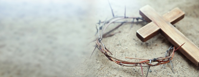 Image of Passion Of Jesus Christ. Crown of thorns and wooden cross on sand, banner design