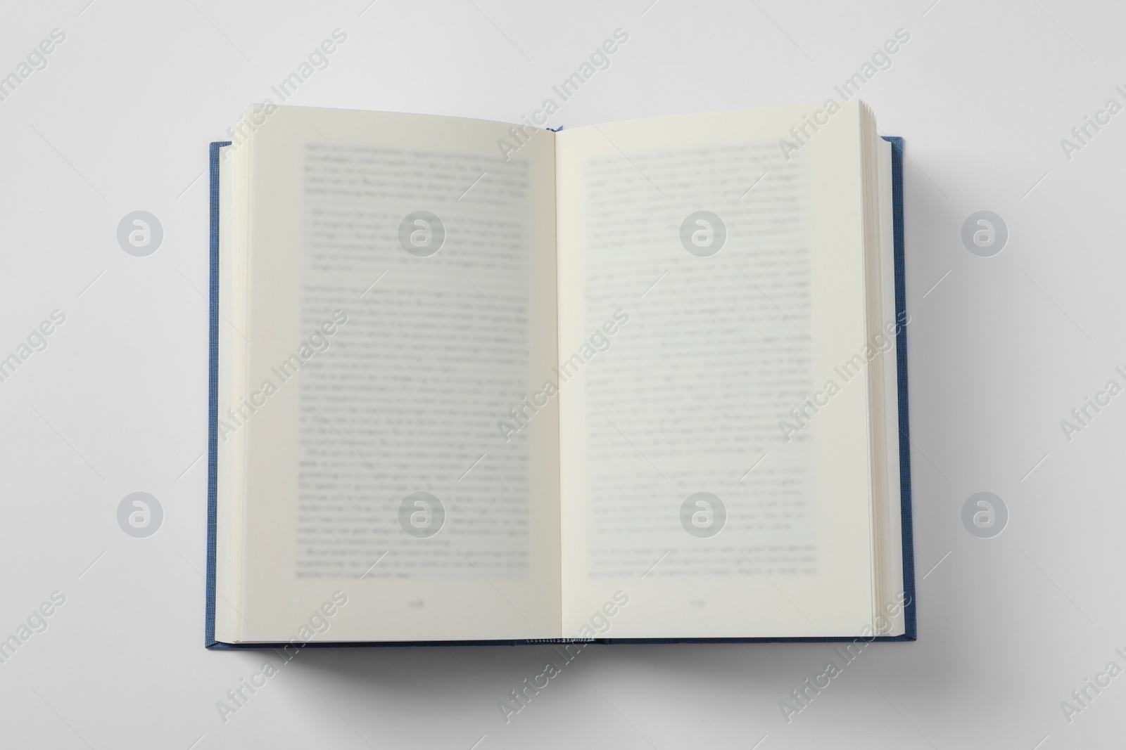 Photo of Open book on white background, top view