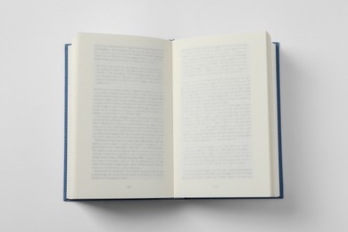 Open book on white background, top view