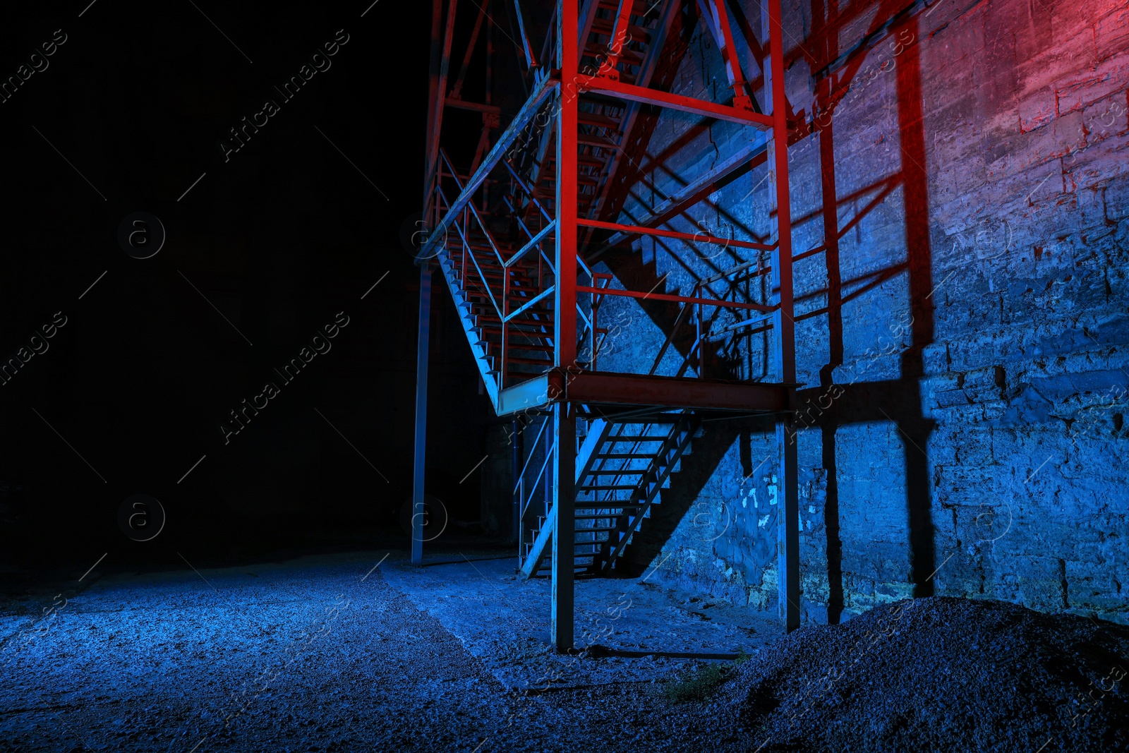 Photo of Old building with fire escape at night