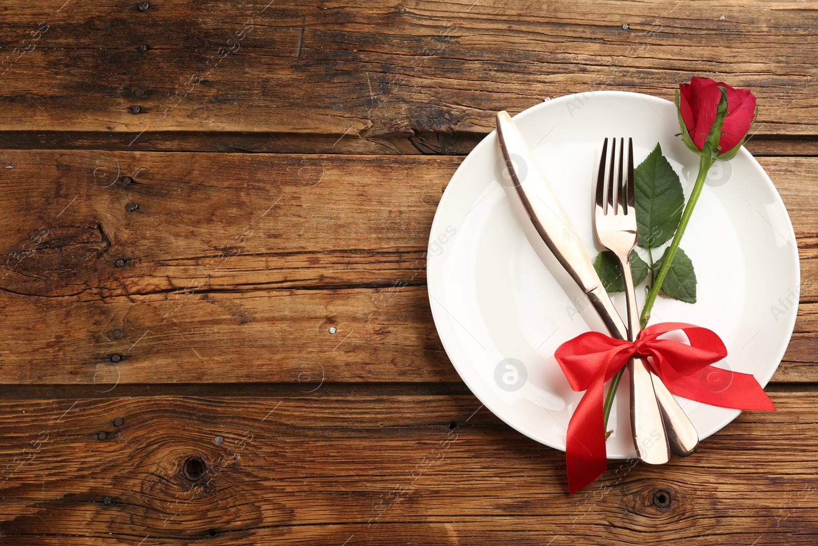 Photo of Beautiful table setting on wooden background, top view with space for text. Valentine's Day dinner