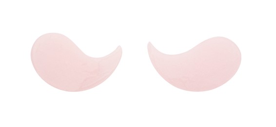 Photo of Pale pink under eye patches isolated on white, top view. Cosmetic product