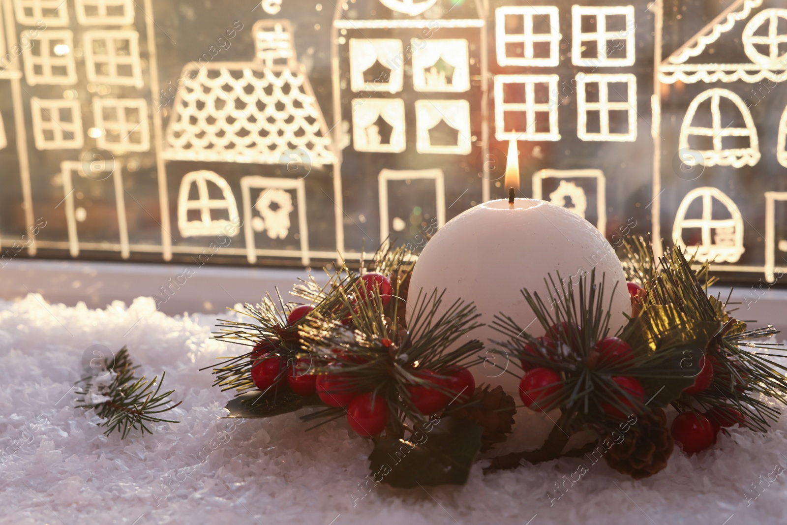 Photo of Beautiful burning candle with Christmas decor near window, space for text