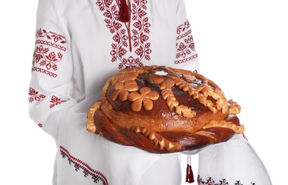 Woman with korovai on white background, closeup. Ukrainian bread and salt welcoming tradition