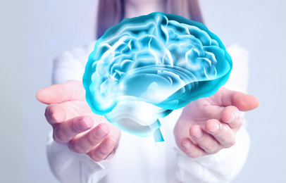 Image of Young woman holding digital image of brain in hands on white background, closeup