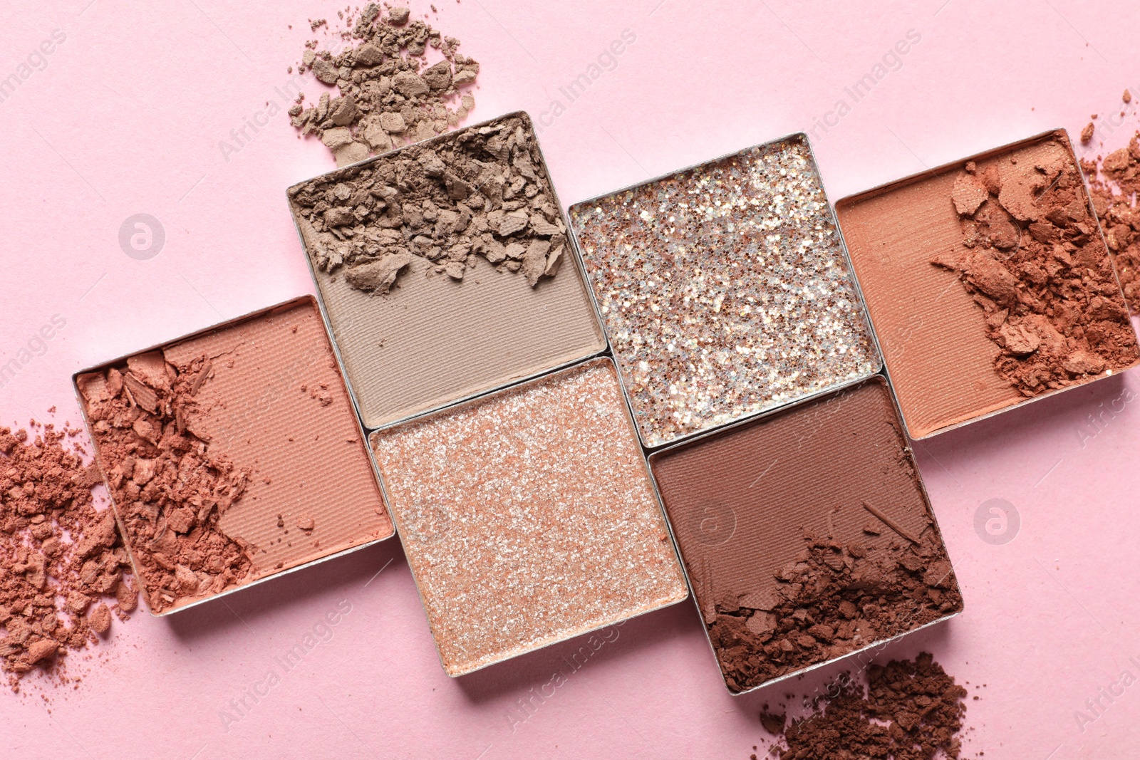 Photo of Crushed eye shadows on pink background, flat lay. Professional makeup product