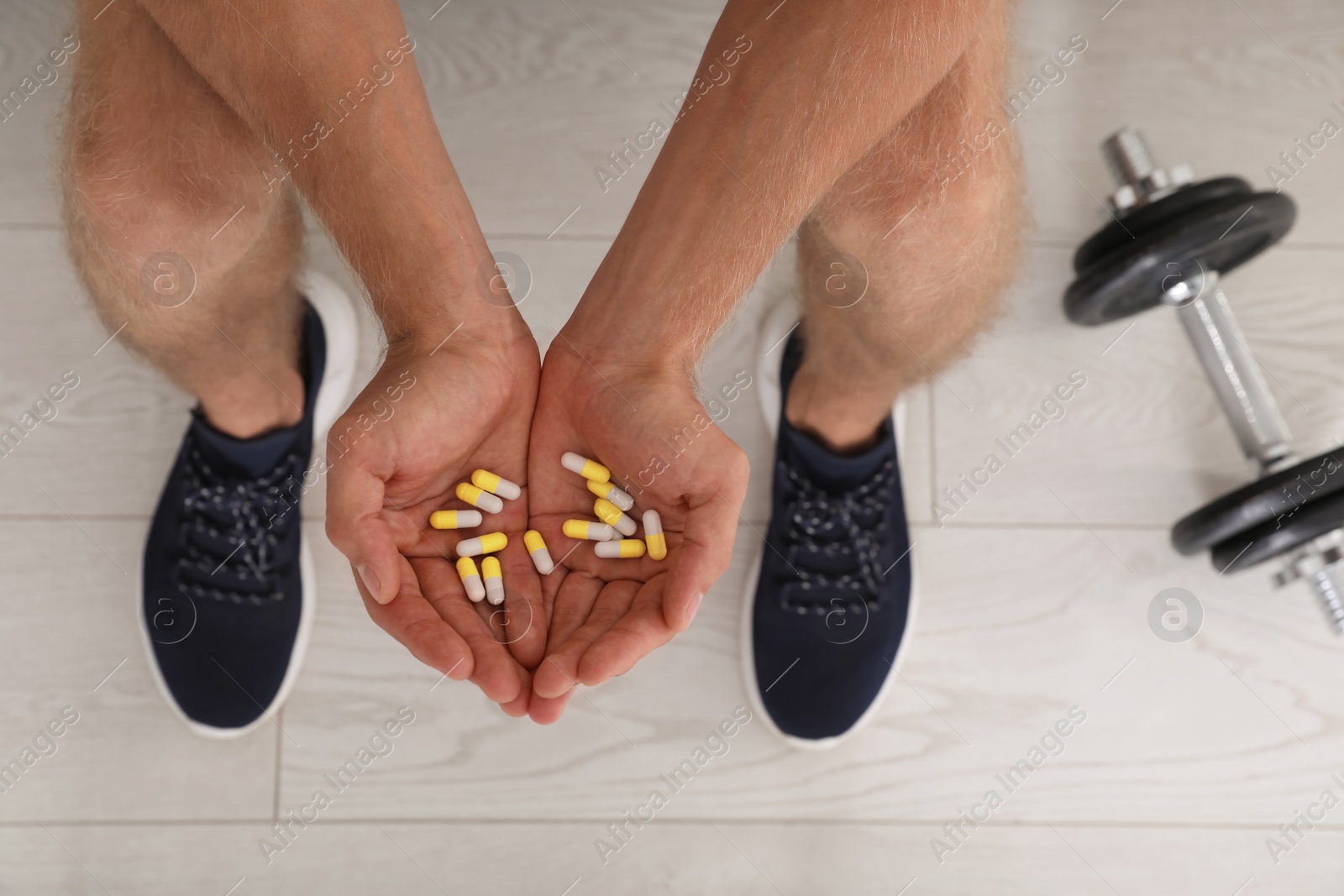 Photo of Man with handful of pills, top view. Doping concept