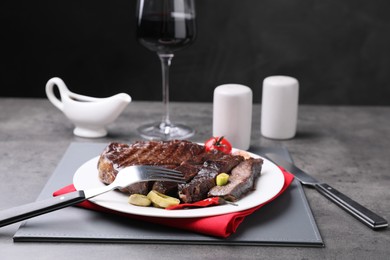Photo of Delicious grilled beef meat served on grey table