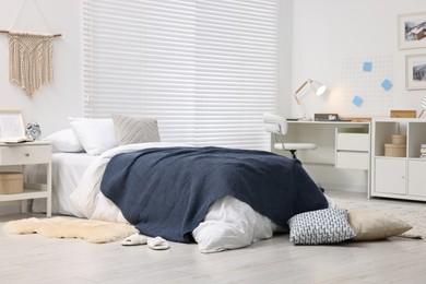 Photo of Bedroom interior with comfortable furniture, big window and white blinds