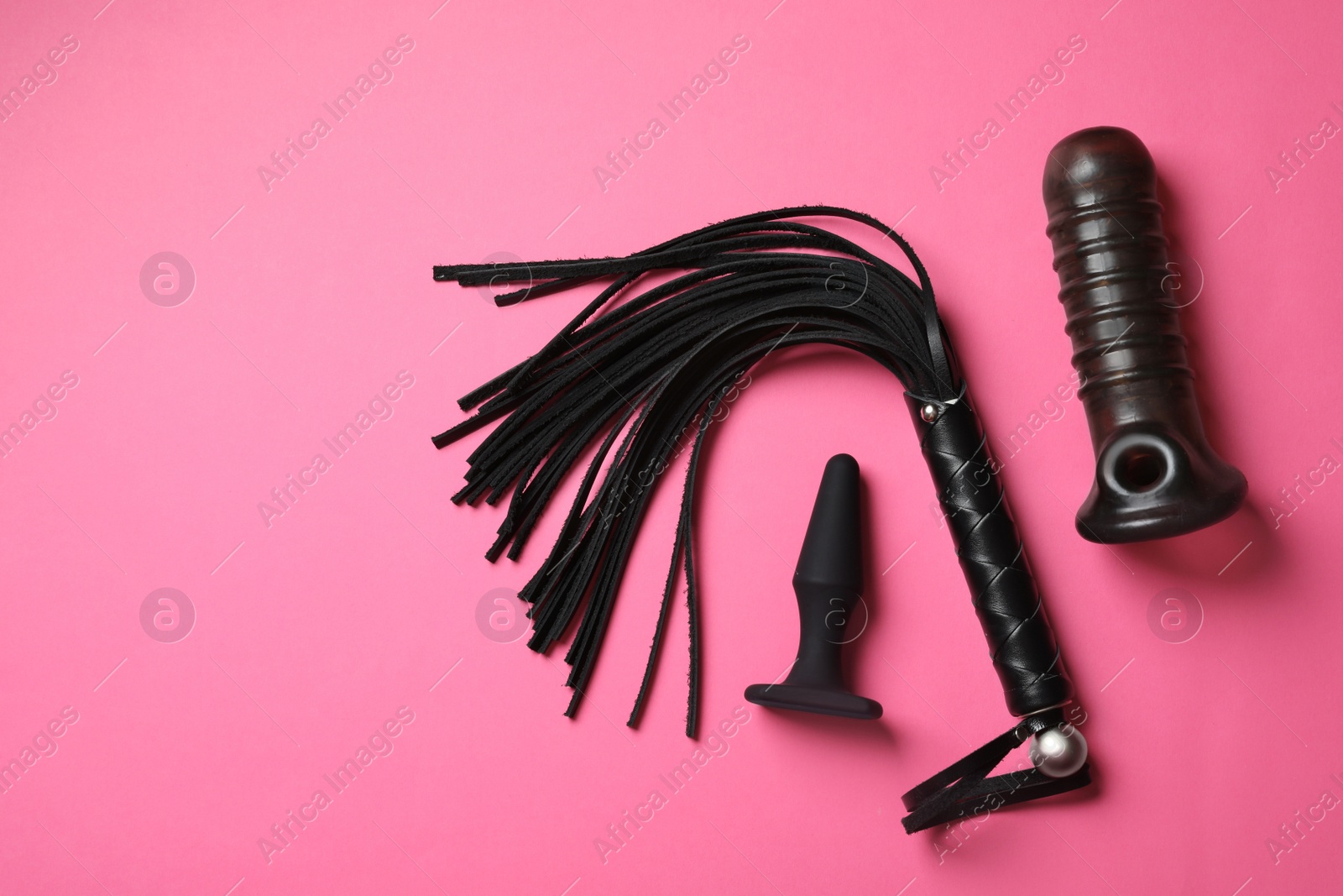Photo of Set of different sex toys on pink background, flat lay. Space for text