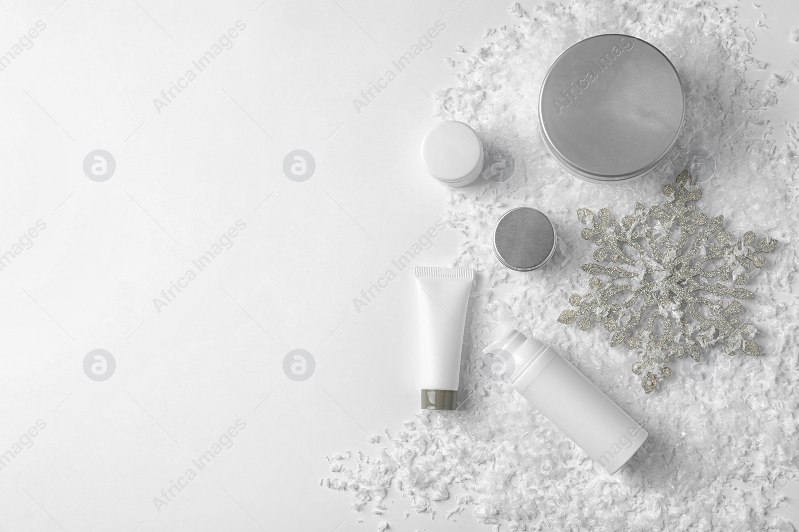 Photo of Set of cosmetic products on white background, flat lay with space for text. Winter care