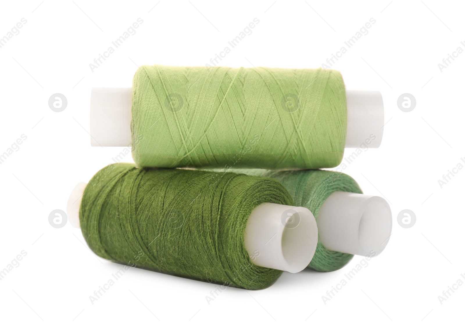 Photo of Different colorful sewing threads on white background