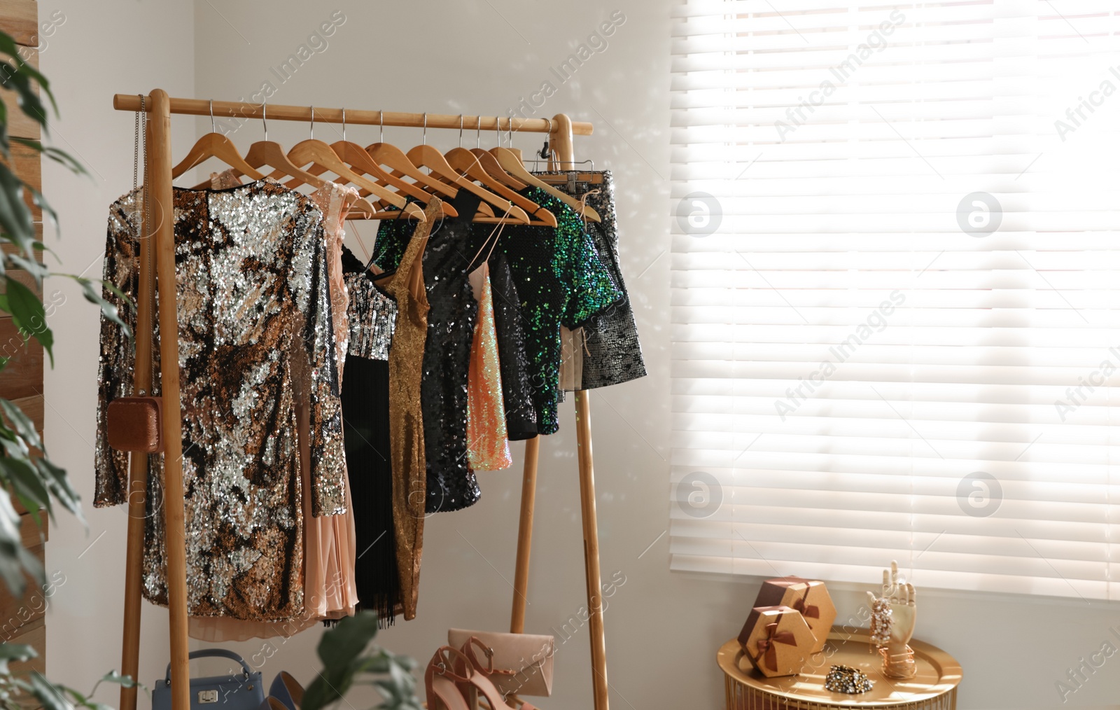 Photo of Rack with stylish women's clothes in room. Interior design