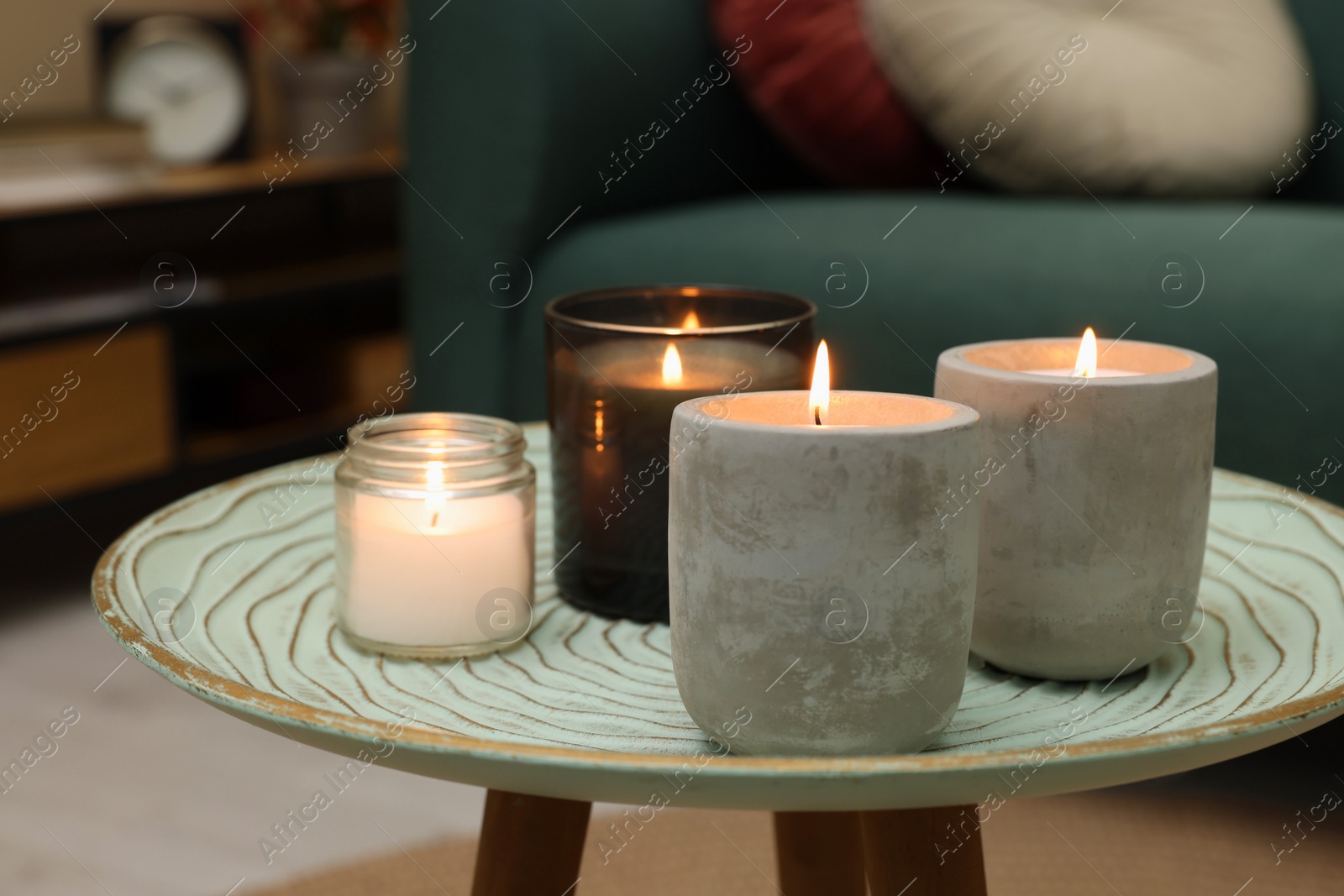 Photo of Lit candles on table in living room