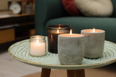 Lit candles on table in living room