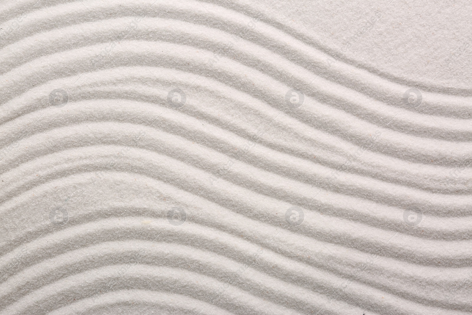 Photo of White sand with pattern as background, top view. Concept of zen and harmony