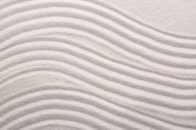 Photo of White sand with pattern as background, top view. Concept of zen and harmony