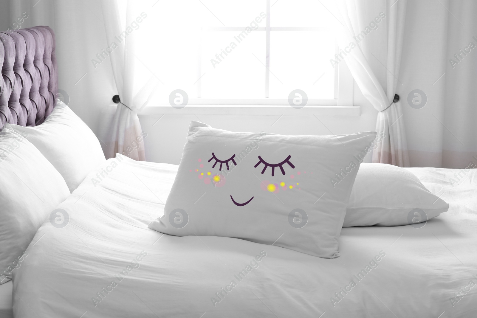 Image of Soft pillow with cute face on comfortable bed in room