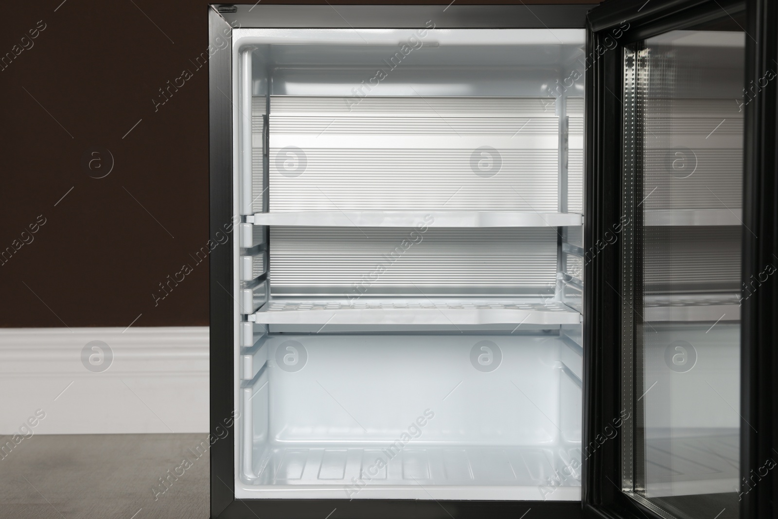 Photo of Empty mini bar near brown wall indoors, closeup