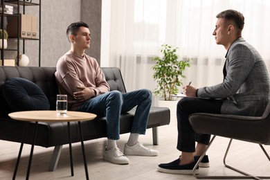 Photo of Professional psychotherapist working with patient in office