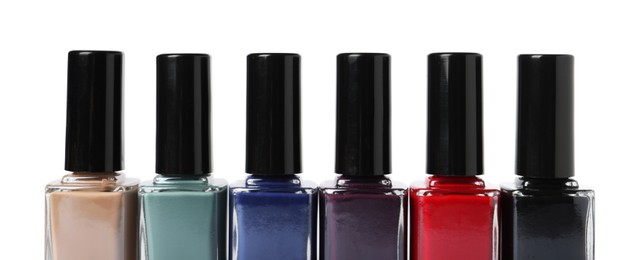 Beautiful nail polishes in bottles isolated on white