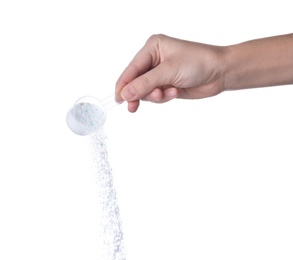 Woman pouring laundry detergent from measuring container against white background, closeup