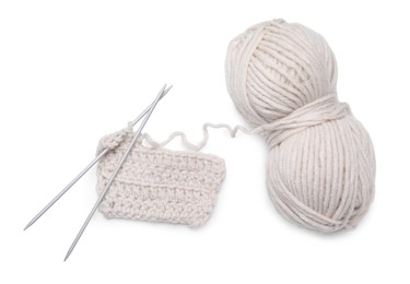 Photo of Soft woolen yarn, knitting and metal needles on white background, top view