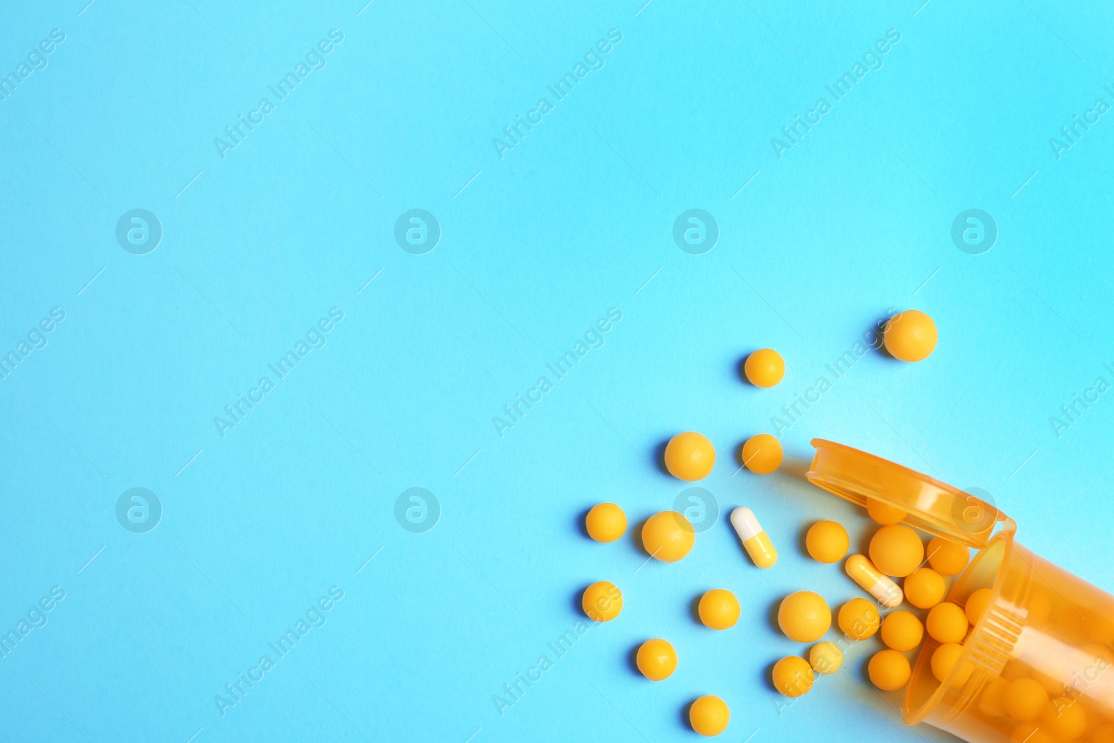 Photo of Flat lay composition with bottle, pills and space for text on color background