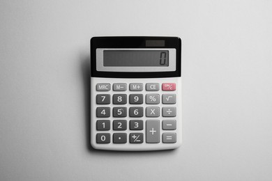 Photo of Calculator on light gray background, top view. Office equipment