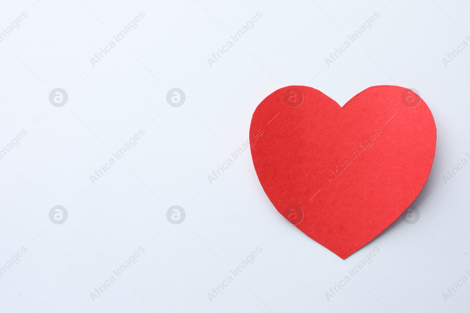 Photo of One paper heart on white background, top view. Space for text