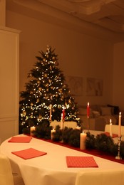 Photo of Red napkins and beautiful Christmas decor indoors. Interior design