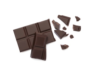 Photo of Pieces of delicious dark chocolate bar on white background, top view