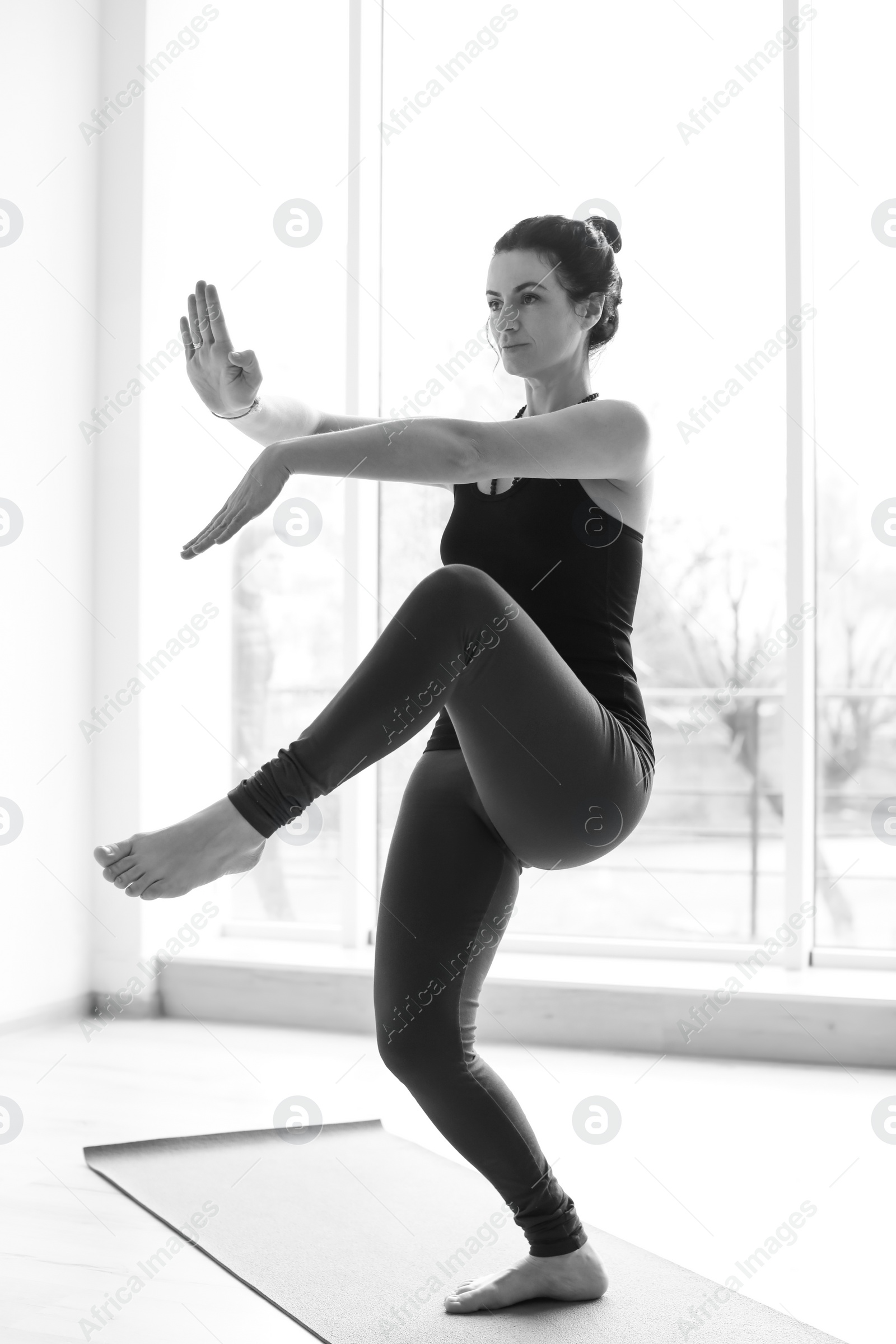 Photo of Sporty woman practicing yoga indoors