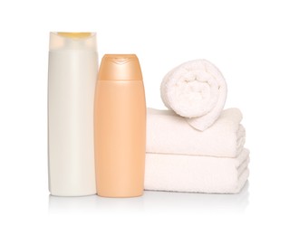 Soft terry towels with cosmetic products on white background