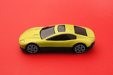 One yellow car on red background. Children`s toy