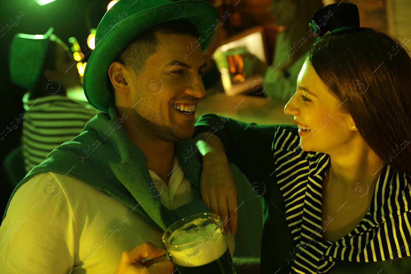 Photo of Couple with beer celebrating St Patrick's day in pub